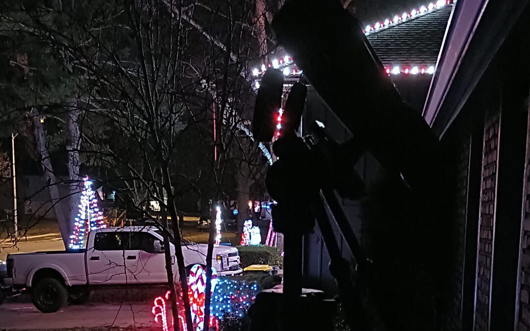 Obwerk 20x70 EDU on my front porch silhouetted against my neighbor's Christmas Vacation style holiday lighting.